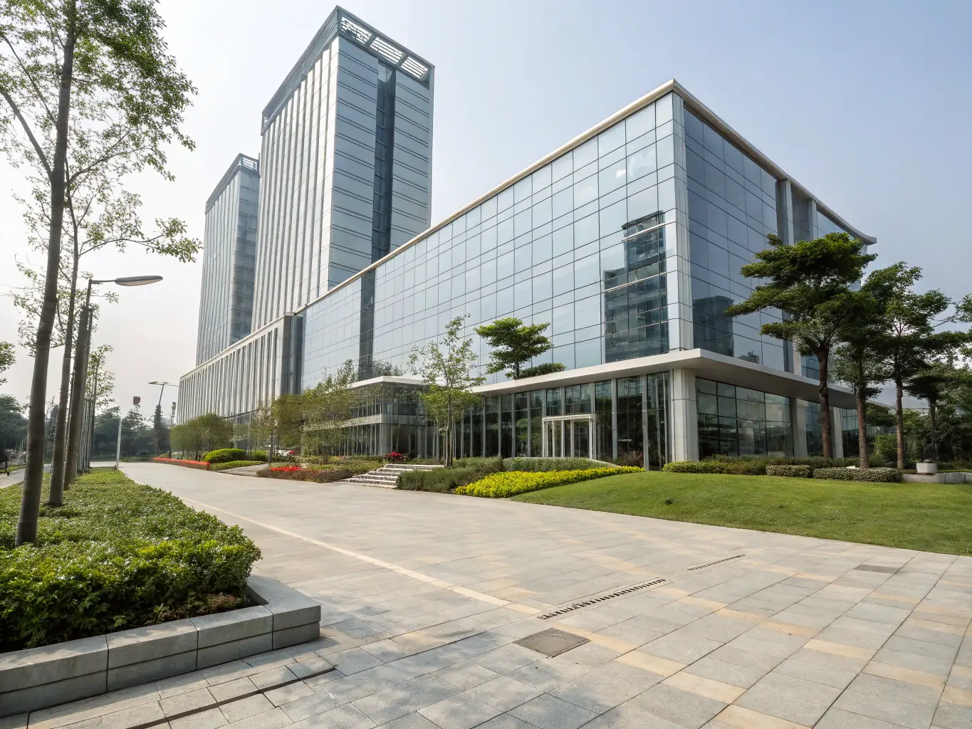 An image of a modern office building with a Dubai skyline in the background, symbolizing business setup in Free Zones.